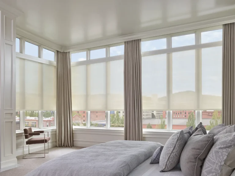 Hunter Douglas Designer Screen Shades in a bedroom Dressed with custom Carole Fabrics Drapery