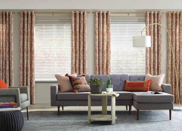 Hunter Douglas Everwood Faux Wood Blinds in living room dressed with custom Carole fabrics drapery side panels