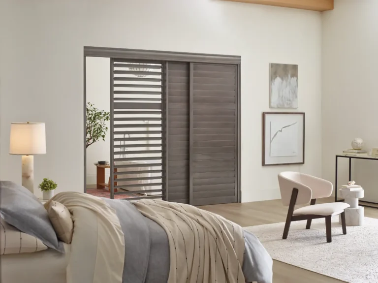 Hunter Douglas Heritance hardwood shutters sliding bypass track acting as door between bathroom and bedroom
