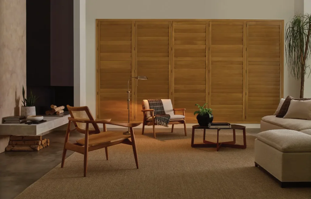 Hunter Douglas Brown Heritance Hardwood Shutters in living room available through ambassador blind n shutter in grand junction colorado