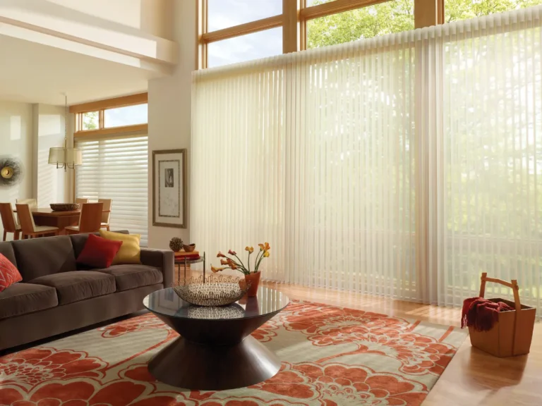 Several tall windows in living room covered by one motorized Hunter Douglas Luminette shade with a Silhouette shade covering a window in the dinning room
