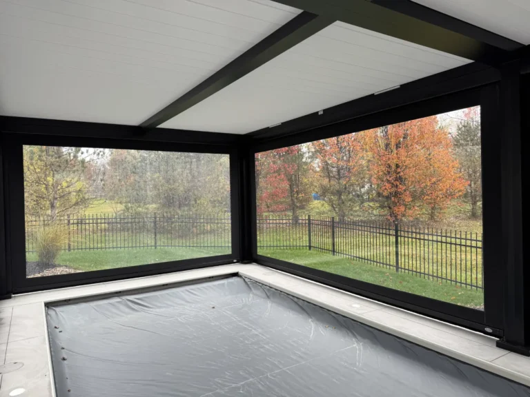 MagnaTrack Vinyl Patio Shades enclosing out door pool to provide protection from weather and the elements