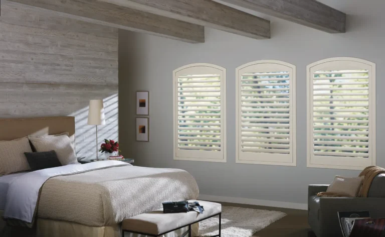 New Style faux wood white shutters with hidden tilt in arch top window in a bedroom