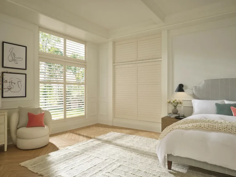 Hunter douglas palm beach vinyl white power view motorized shutters in a bedroom available through ambassador blind n shutter in grand junction colorado